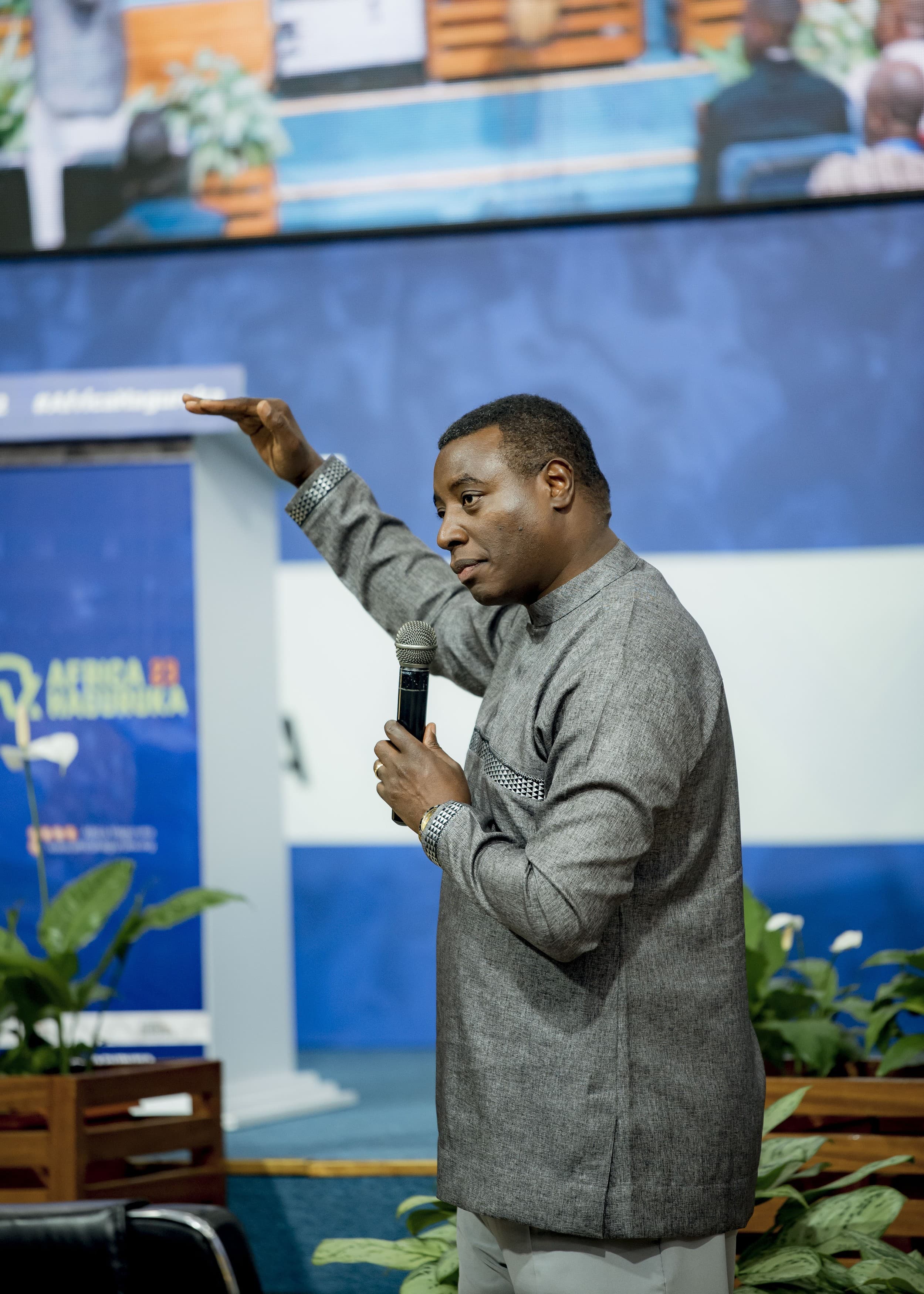 African speaker with microphone at conference